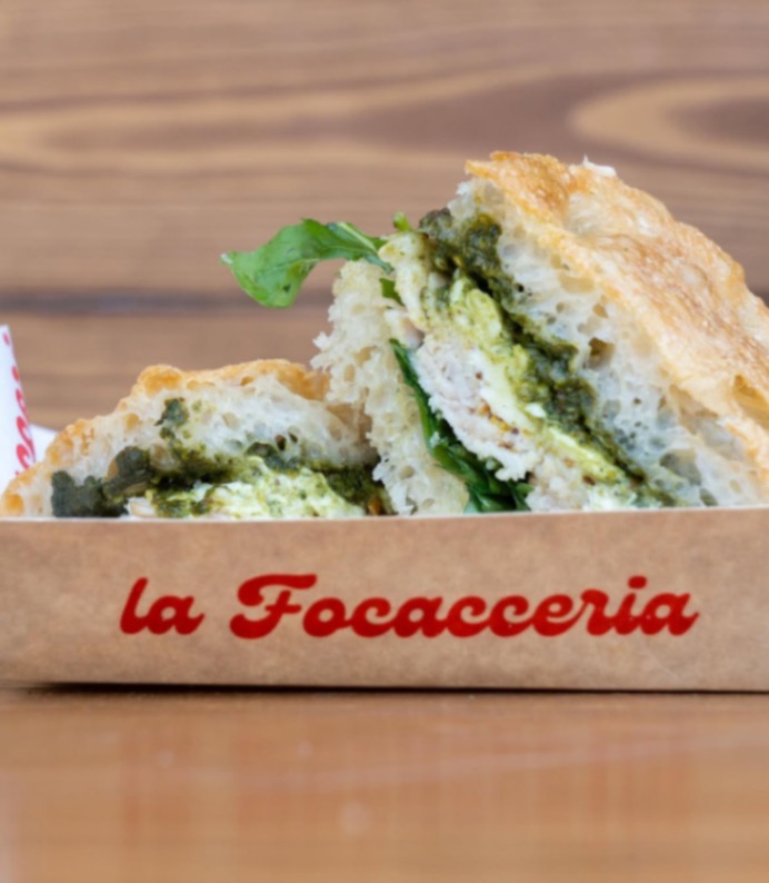 Pesto Fresco focaccia sandwich in a La Focacceria paper tray